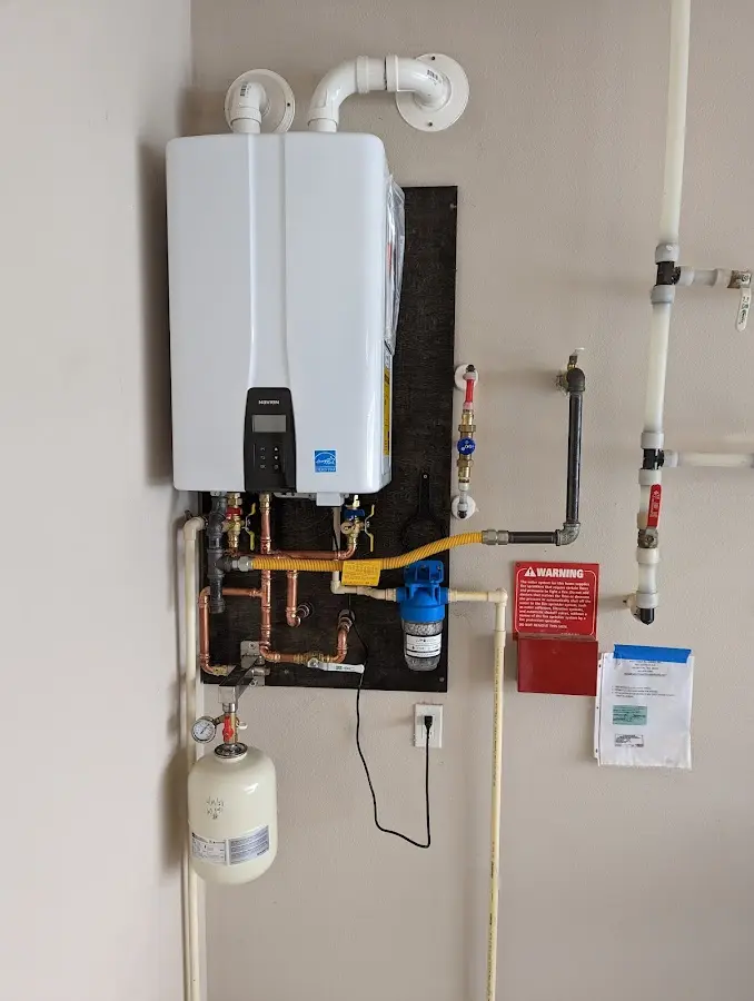 Professional plumber installing copper piping in a Lowell home